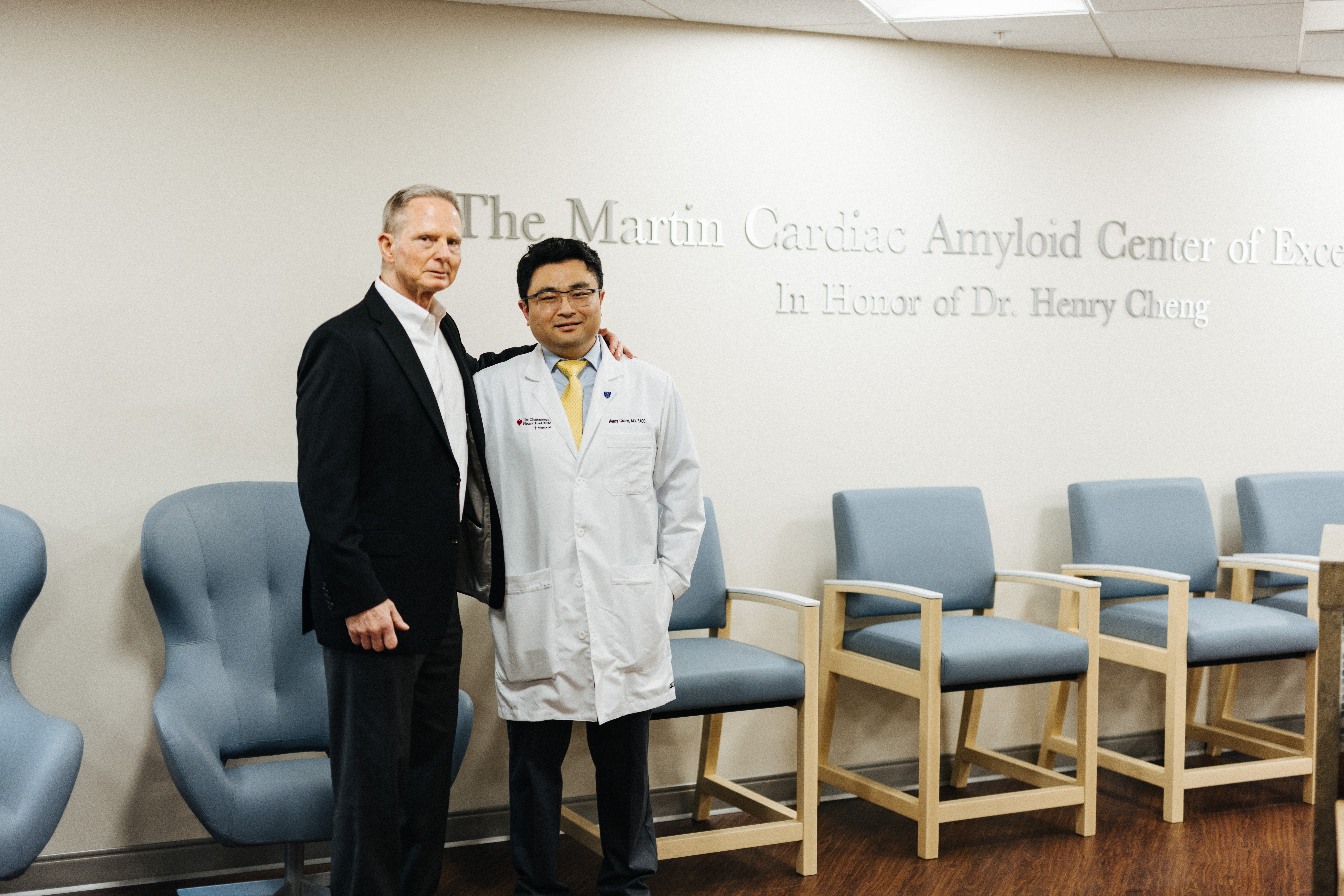 two gentlemen standing in front of chairs announcing new amyloid center